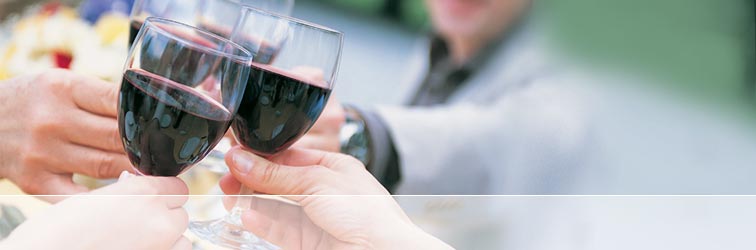 Group of people toasting glasses of red wine